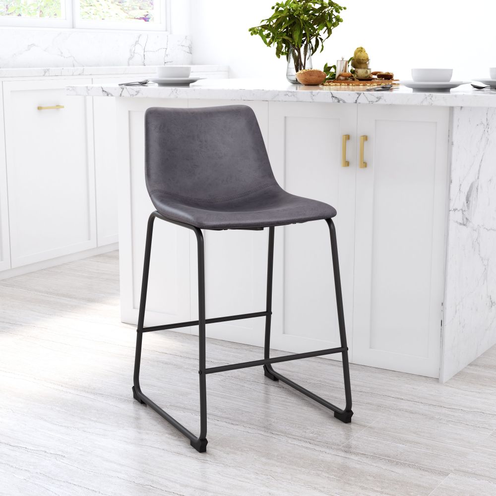 Gray bar stool in a kitchen setting with white cabinets and a light wood floor.