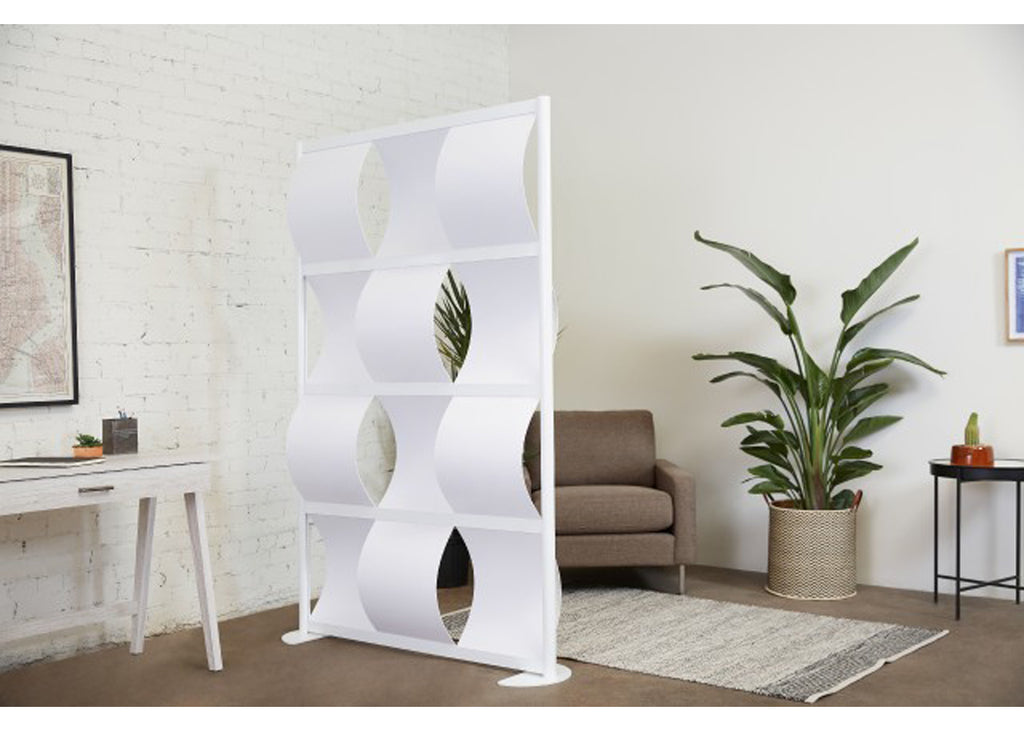 White wave wall room divider in a modern living room with a couch and plants.