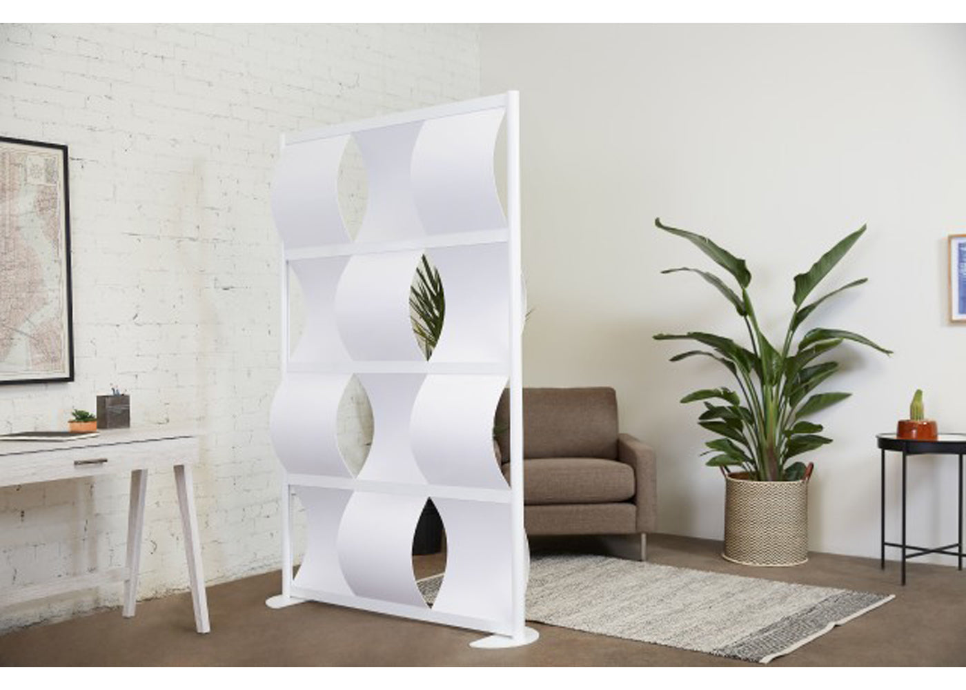 White wave wall room divider in a modern living room with a couch and plants.